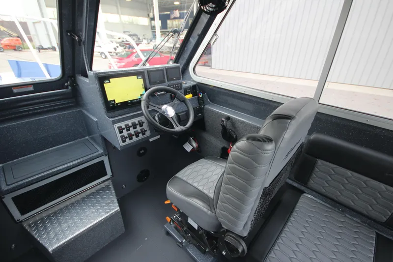 Slide: The Image of 2025 Weldcraft 240 Ocean King boat interior with steering wheel and navigation system. - 38