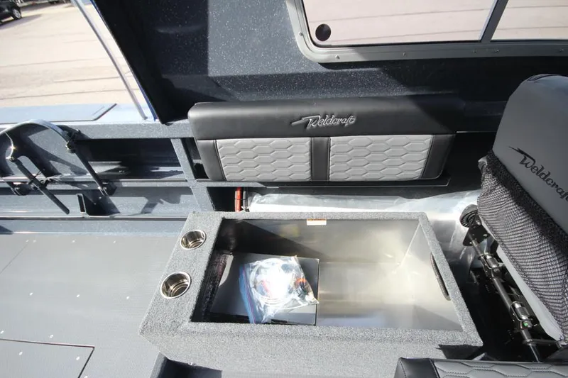 Slide: The Image of Interior of 2025 Weldcraft 240 Ocean King boat, featuring seating and storage compartment. - 39