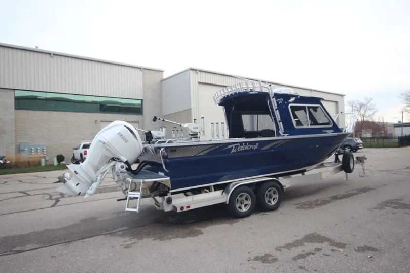 Slide: The Image of 2025 Weldcraft 240 Ocean King boat on trailer, Great Lakes Edition, parked outdoors. - 5