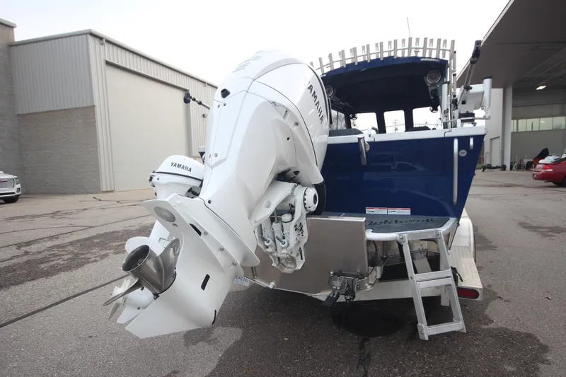Slide: The Image of 2025 Weldcraft 240 Ocean King boat with Yamaha engine, parked outdoors. - 7