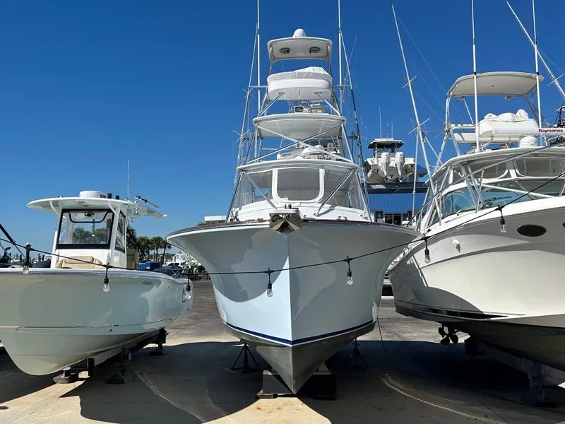 Slide: The Image of 2006 Miller 36 Express boat docked between two other boats under clear blue sky. - 41