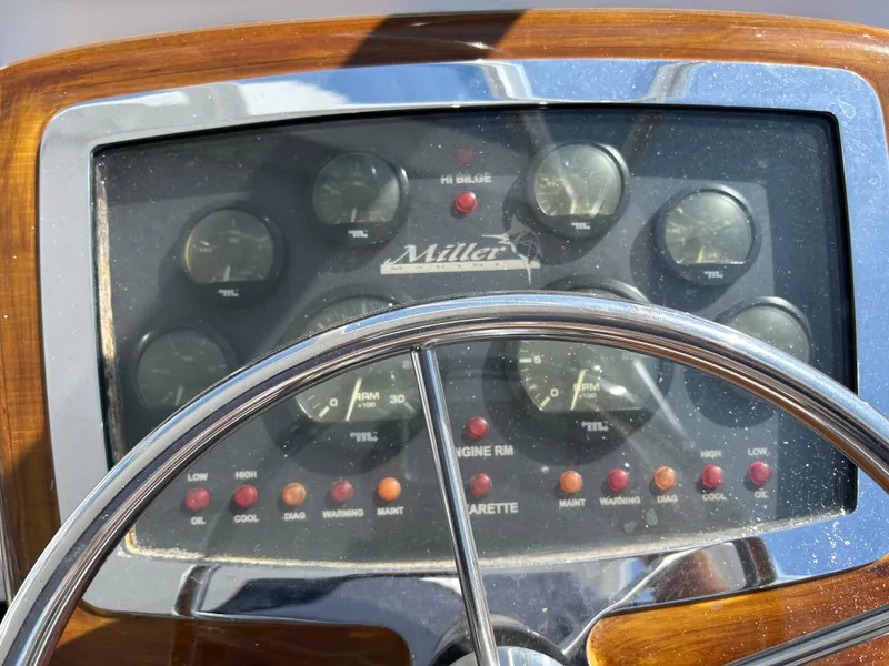 Slide: The Image of Dashboard of a 2006 Miller 36 Express boat with steering wheel and gauges. - 46
