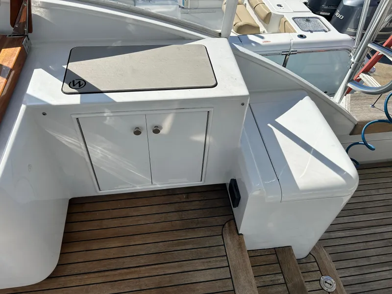Slide: The Image of 2006 Miller 36 Express boat deck with storage and seating area. - 48