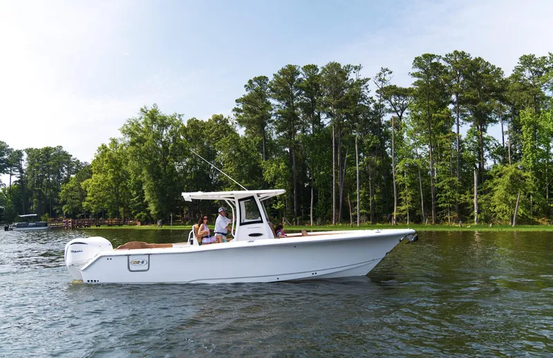 Slide: The Image of 2025 Sea Hunt Ultra 305 SE boat cruising on a scenic lake. - 13