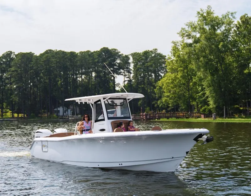 Slide: The Image of 2025 Sea Hunt Ultra 305 SE boat cruising on a scenic lake. - 22