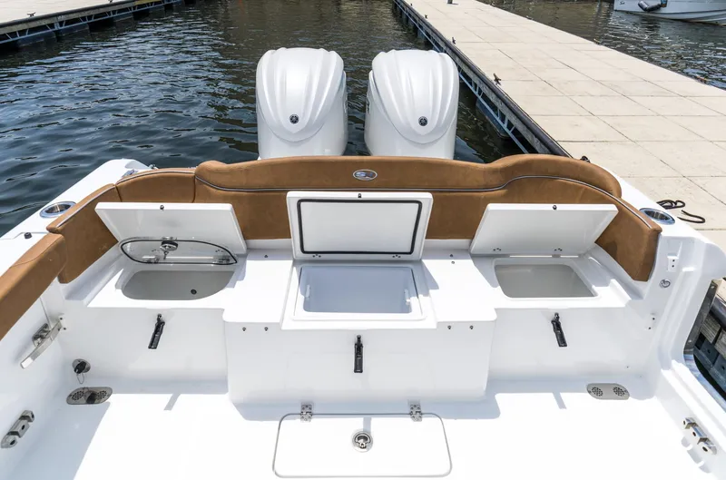 Slide: The Image of 2025 Sea Hunt Ultra 305 SE boat interior with storage compartments and twin engines. - 4