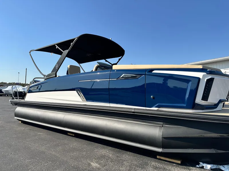 Slide: The Image of 2025 Balise HORIZON 24L pontoon boat with sleek blue design and canopy. - 4