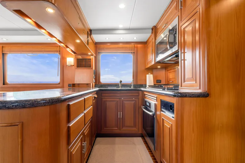 Slide: The Image of Luxurious kitchen interior of 2007 Fleming 65 yacht with wooden cabinetry and modern appliances. - 13