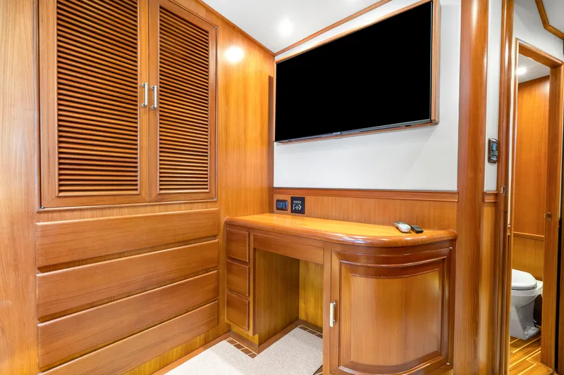 Slide: The Image of Luxurious wooden interior of 2007 Fleming 65 yacht with TV and cabinetry. - 19
