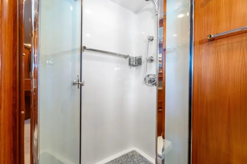 Slide: The Image of Luxurious shower in 2007 Fleming 65 yacht with glass doors and wooden accents. - 21