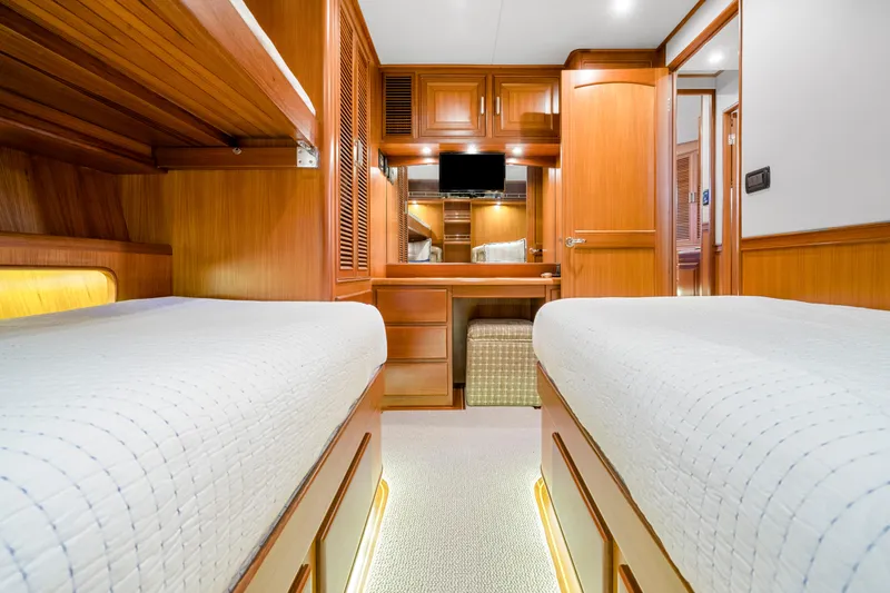 Slide: The Image of Luxurious 2007 Fleming 65 yacht cabin with twin beds and elegant wood finish. - 24