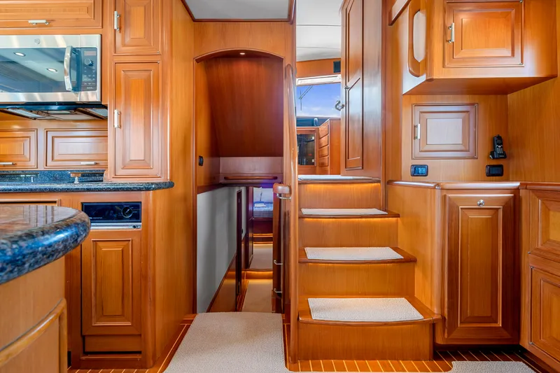 Slide: The Image of Luxurious wooden interior of a 2007 Fleming 65 yacht with stairs and cabinetry. - 26