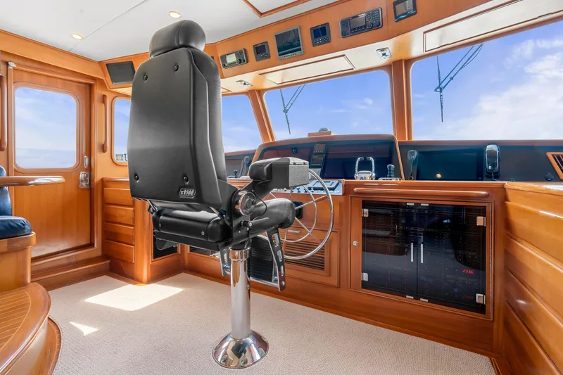 Slide: The Image of Pilothouse interior of 2007 Fleming 65 yacht with captain's chair and navigation controls. - 28