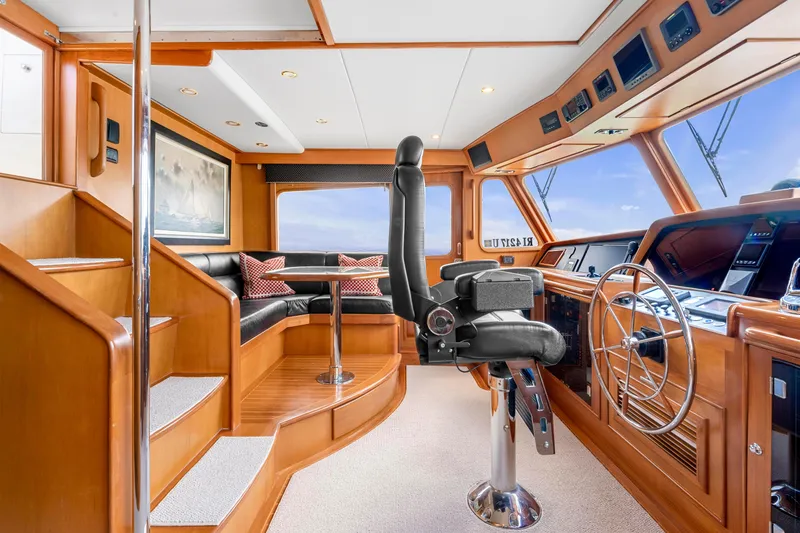 Slide: The Image of Luxurious 2007 Fleming 65 yacht interior with captain's chair and navigation controls. - 3
