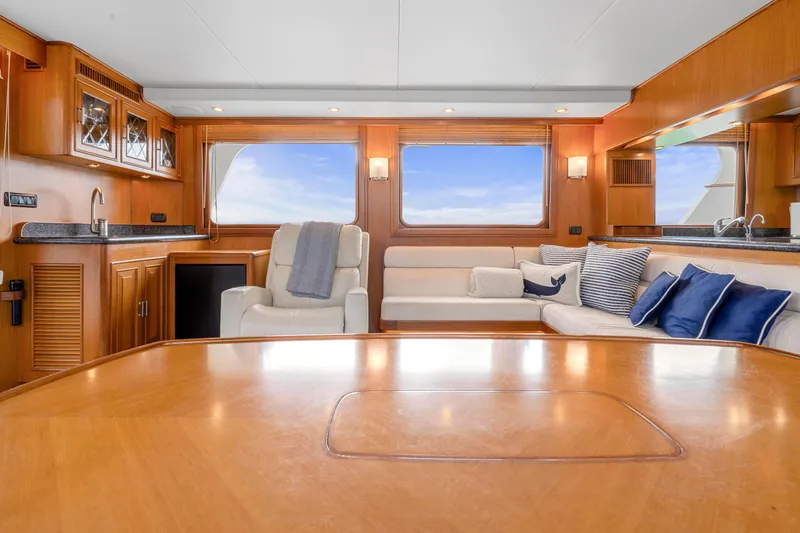 Slide: The Image of Luxurious 2007 Fleming 65 yacht interior with elegant wood finishes and plush seating. - 34