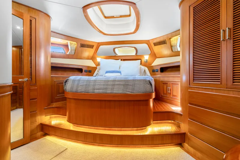 Slide: The Image of Luxurious cabin interior of 2007 Fleming 65 yacht with elegant wood finish and cozy bedding. - 4
