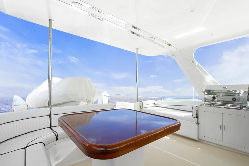Slide: The Image of Luxurious 2007 Fleming 65 yacht deck with seating, table, and ocean view. - 41