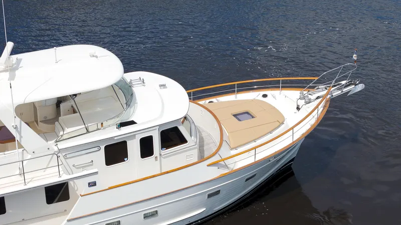 Slide: The Image of Luxury 2007 Fleming 65 yacht on calm water, showcasing elegant design and spacious deck. - 48