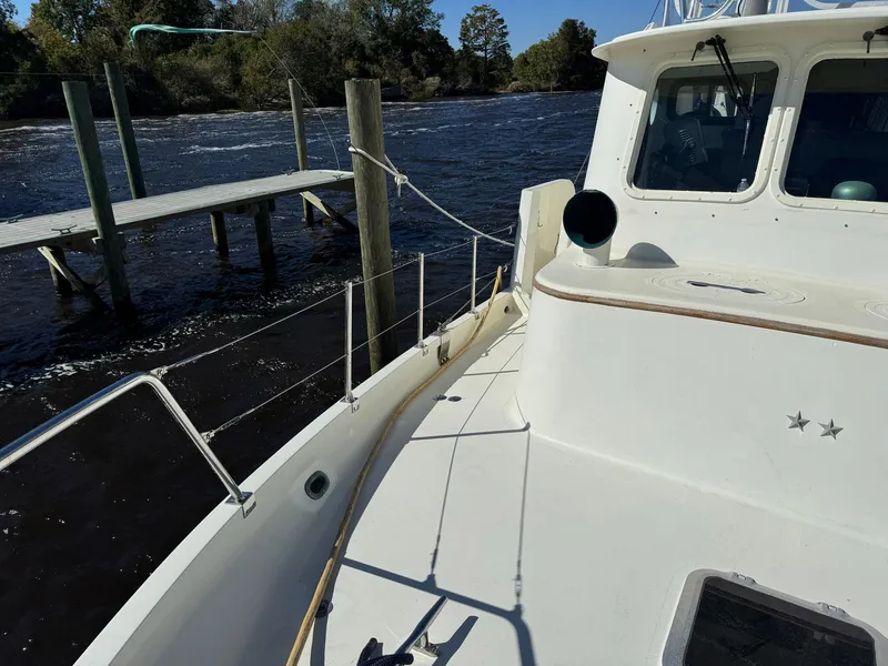 Slide: The Image of 1989 Seaton Ross 56 Trawler docked by a wooden pier on a sunny day. - 11
