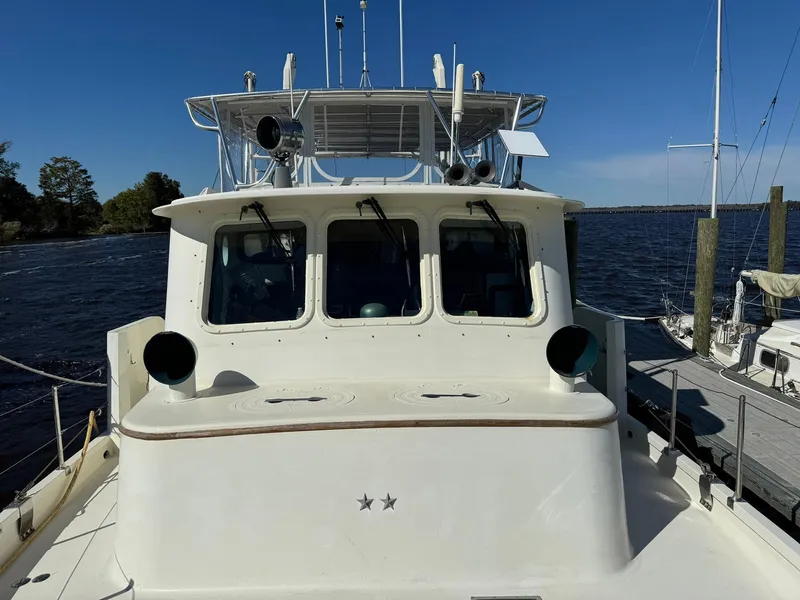 Slide: The Image of Seaton Ross 56 Trawler 1989, docked, front view, clear sky, calm water. - 12