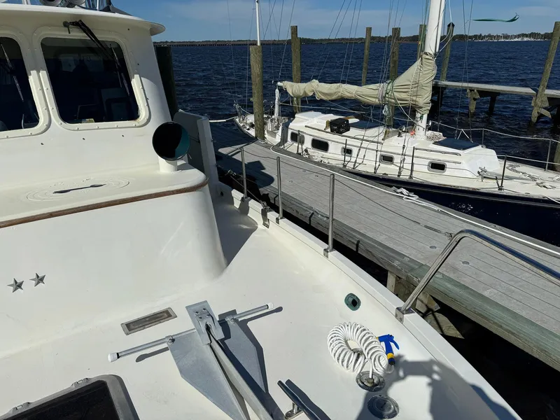 Slide: The Image of Seaton Ross 56 Trawler 1989 docked beside a sailboat on a sunny day. - 13