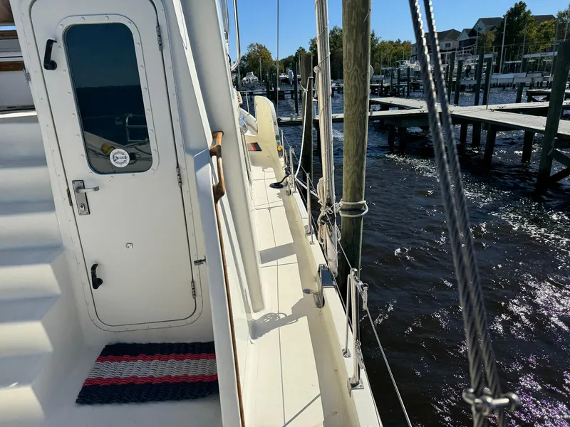 Slide: The Image of Seaton Ross 56 Trawler 1989 docked, showing side deck and marina view. - 16