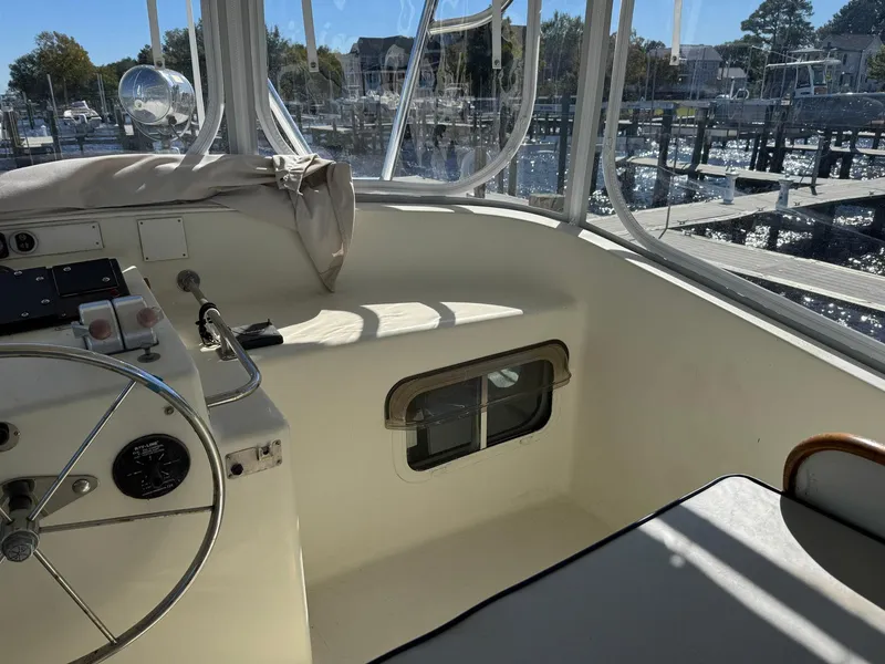 Slide: The Image of Interior view of 1989 Seaton Ross 56 Trawler helm with marina background. - 19