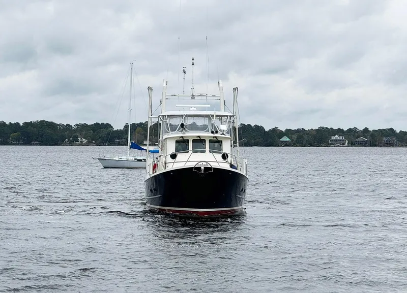 Slide: The Image of 1989 Seaton Ross 56 Trawler on a cloudy day, cruising on a calm lake. - 2