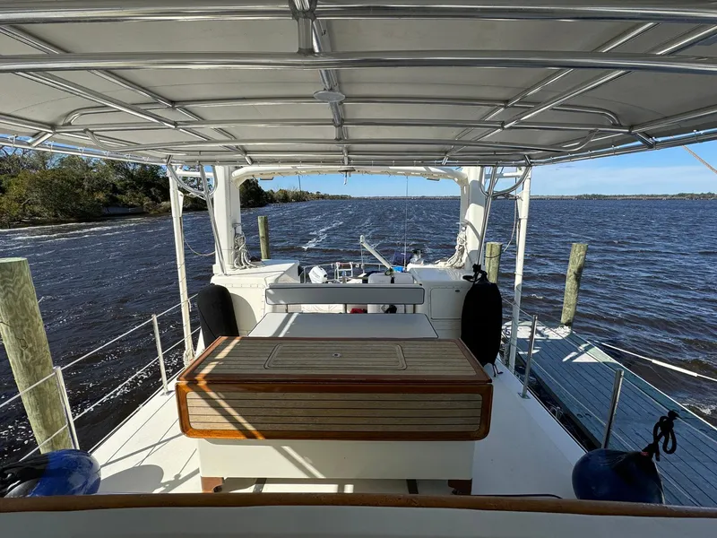 Slide: The Image of Seaton Ross 56 Trawler 1989, spacious deck view, docked by calm waters. - 22