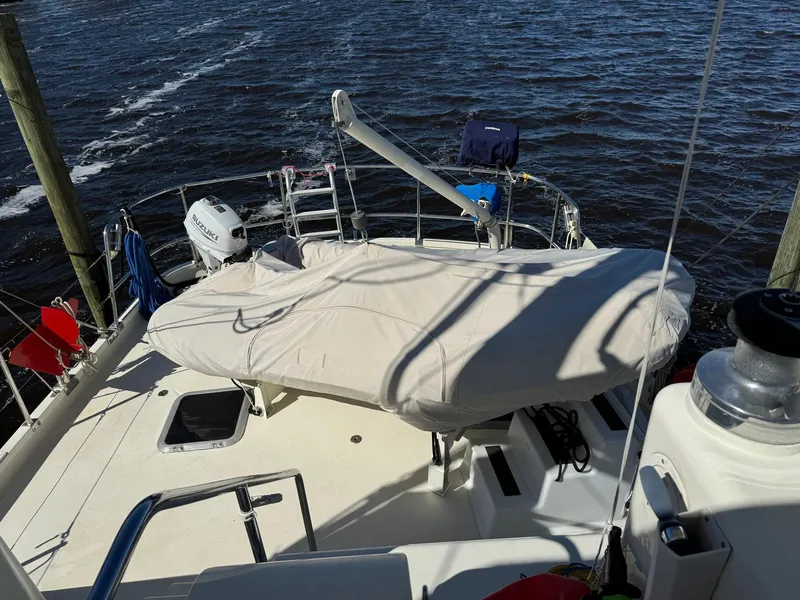 Slide: The Image of Seaton Ross 56 Trawler 1989 deck view with covered equipment and ocean backdrop. - 23