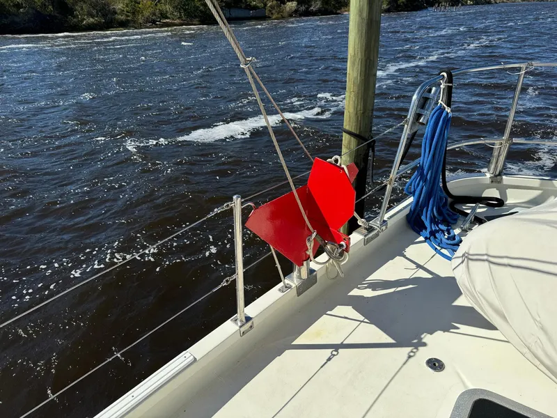 Slide: The Image of Seaton Ross 56 Trawler 1989 deck with red anchor and blue rope by the water. - 24
