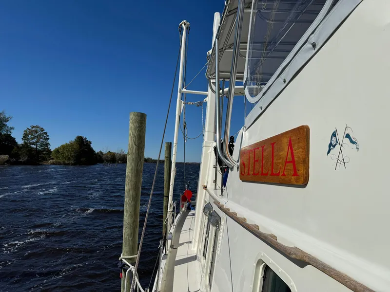 Slide: The Image of Seaton Ross 56 Trawler 1989 docked by a scenic river under clear blue skies. - 26