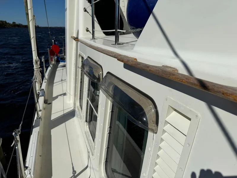 Slide: The Image of 1989 Seaton Ross 56 Trawler deck with windows and railing, sailing on open water. - 27