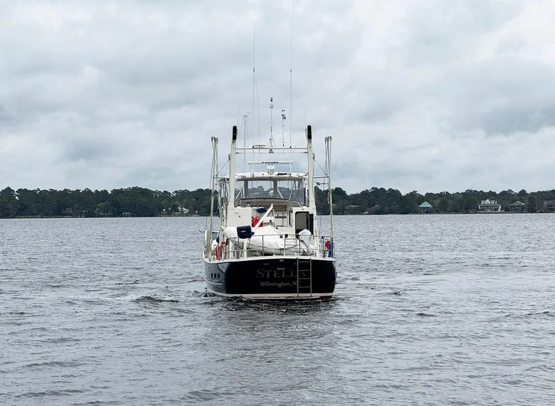 Slide: The Image of Seaton Ross 56 Trawler, 1989, cruising on a calm lake under cloudy skies. - 34
