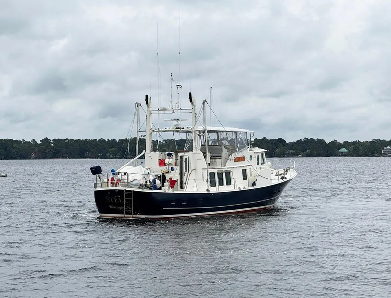 Slide: The Image of 1989 Seaton Ross 56 Trawler on a calm lake under cloudy skies. - 35