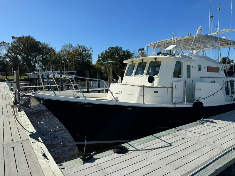 Slide: The Image of 1989 Seaton Ross 56 Trawler docked at marina under clear blue sky. - 36