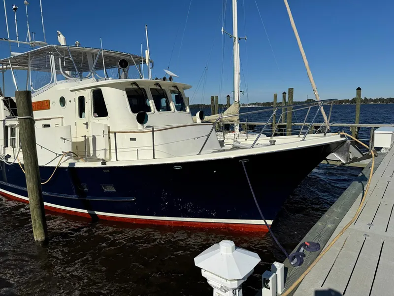 Slide: The Image of 1989 Seaton Ross 56 Trawler docked at marina under clear blue sky. - 37