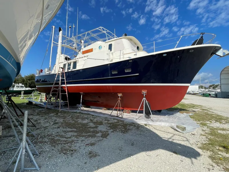 Slide: The Image of 1989 Seaton Ross 56 Trawler on dry dock, blue and red hull, clear sky background. - 38