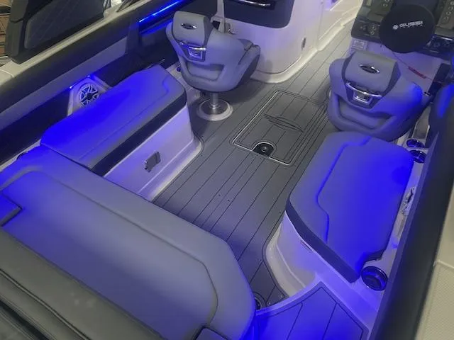 Slide: The Image of Interior of 2025 Chaparral 267 SSX boat with blue LED lighting and modern seating. - 6