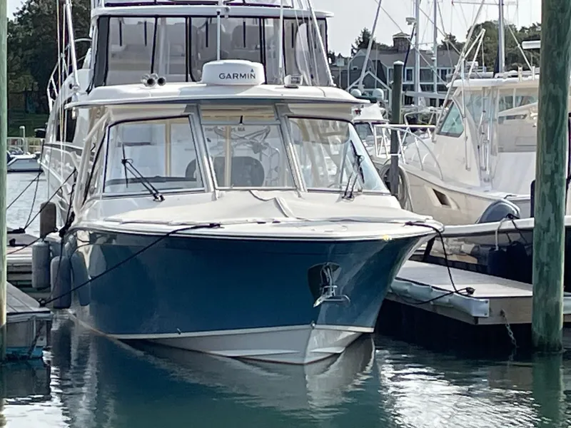 Slide: The Image of 2021 Grady-White Freedom 325 boat docked in marina, front view. - 11