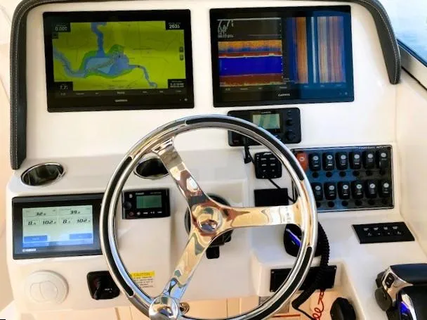 Slide: The Image of 2021 Grady-White Freedom 325 dashboard with navigation screens and controls. - 12