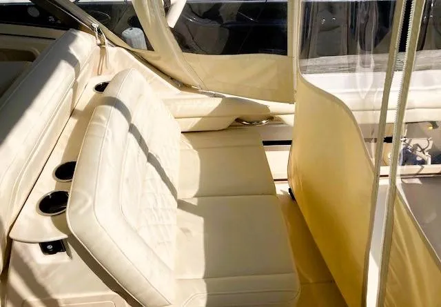 Slide: The Image of 2021 Grady-White Freedom 325 boat interior with beige seating and cup holders. - 14