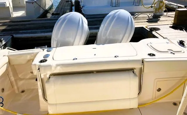 Slide: The Image of 2021 Grady-White Freedom 325 boat docked, featuring dual outboard engines. - 15