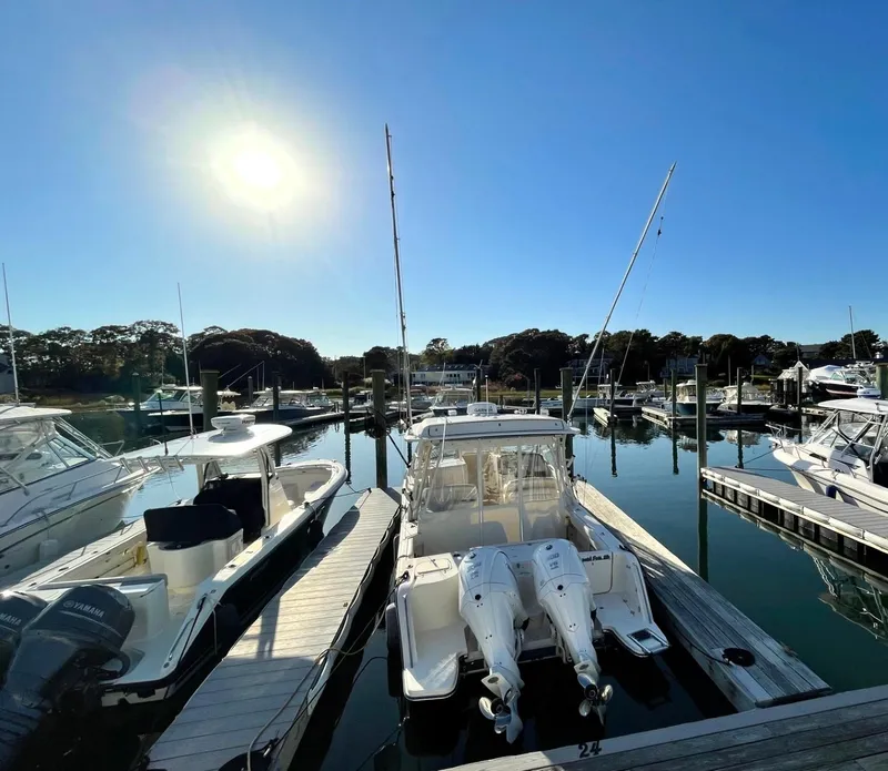 Slide: The Image of 2021 Grady-White Freedom 325 boat docked in a sunny marina. - 2