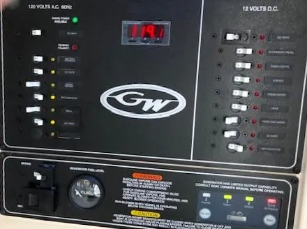 Slide: The Image of Control panel of a 2021 Grady-White Freedom 325 boat, showing voltage and switches. - 21