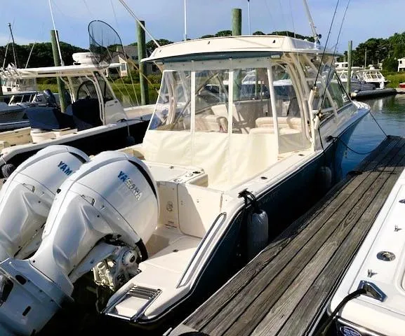 Slide: The Image of 2021 Grady-White Freedom 325 boat docked with twin Yamaha engines. - 5