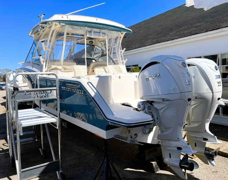 Slide: The Image of 2021 Grady-White Freedom 325 boat with dual Yamaha engines, docked outdoors. - 7