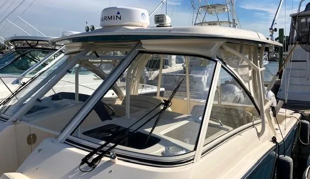 Slide: The Image of 2021 Grady-White Freedom 325 boat docked with Garmin equipment visible. - 8