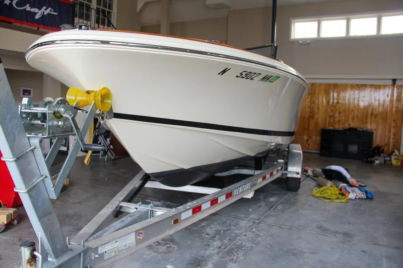 Slide: The Image of 2014 Chris-Craft Launch 22 boat on trailer in garage setting. - 16