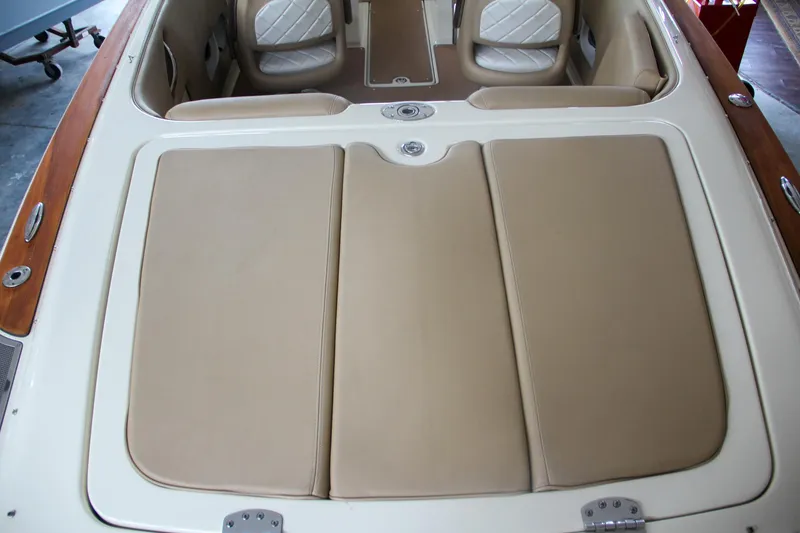 Slide: The Image of 2014 Chris-Craft Launch 22 boat interior with beige seating and wood accents. - 23